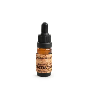 Amber glass dropper bottle with cork label showing Initiation essential oil blend