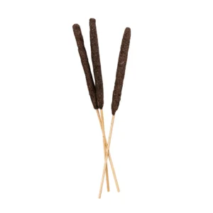 Three dark brown ritual incense sticks with bamboo stems arranged in a fan pattern